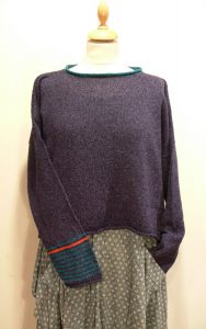 Strathy Short Tunic in gentian/teal/flame. One striped sleeve. Knitted in silk/lambswool. Designed and made in Orkney.